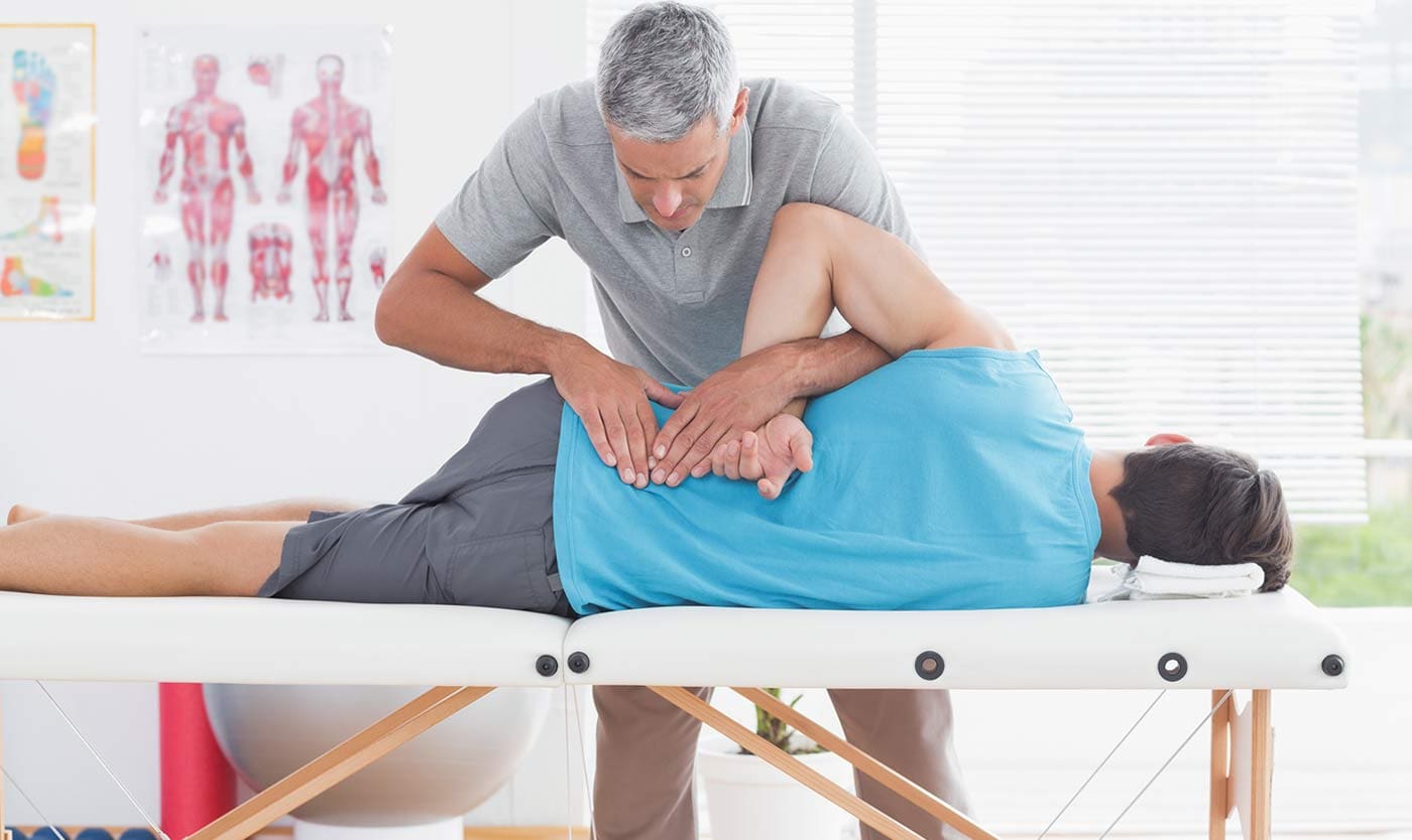 Image of a chiropractor using spinal adjustments to treat a patient for low back pain.